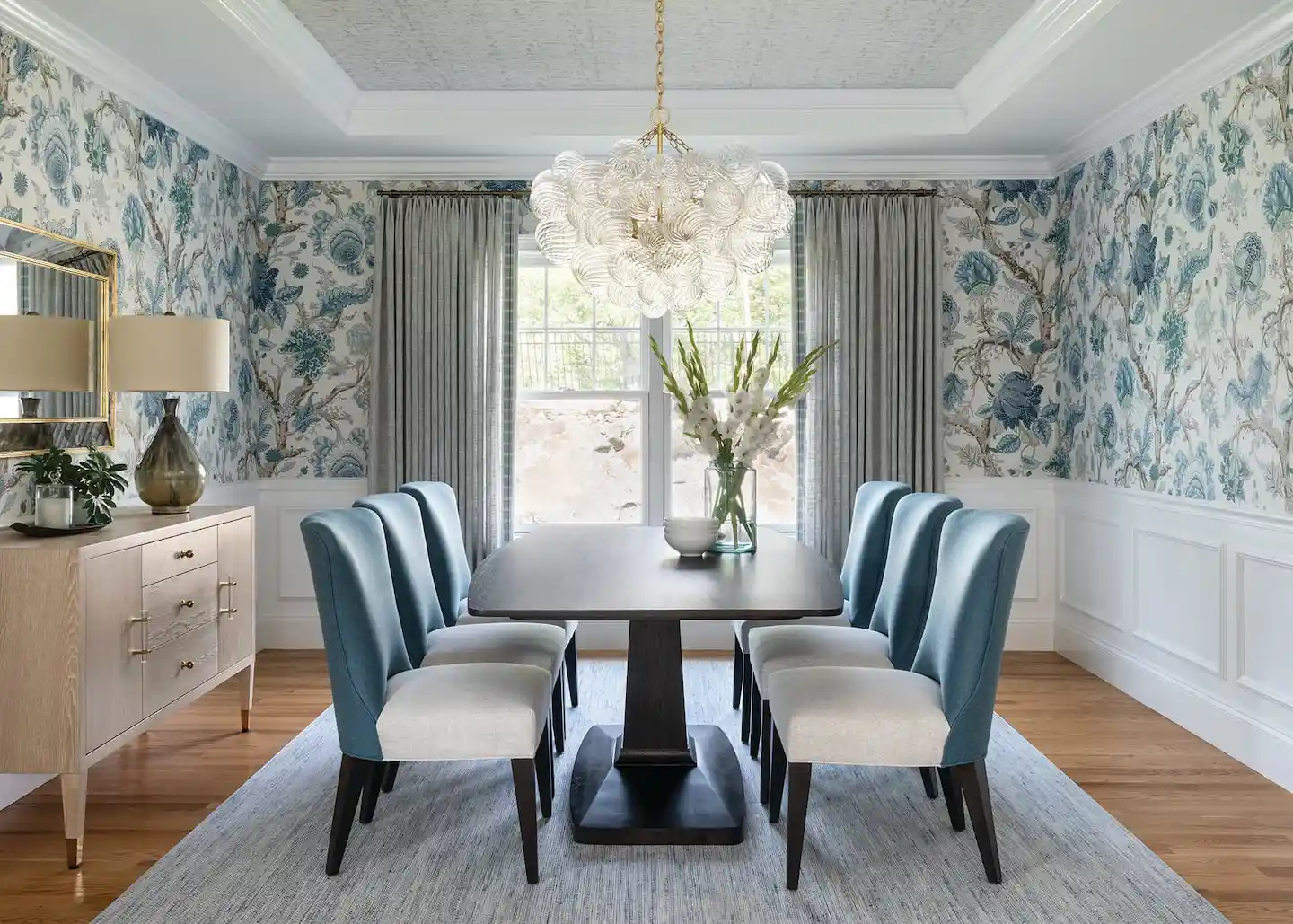 Dining room with a patterned feature wall and a long table